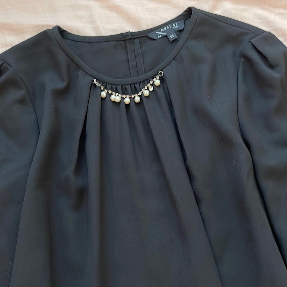 Black blouse with decorative necklace